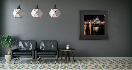 A photography of Venice within a black picture frame and hung within a hallway